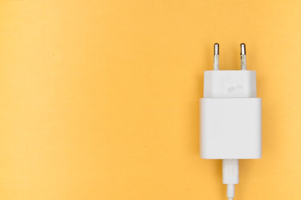 white adapter on yellow wall